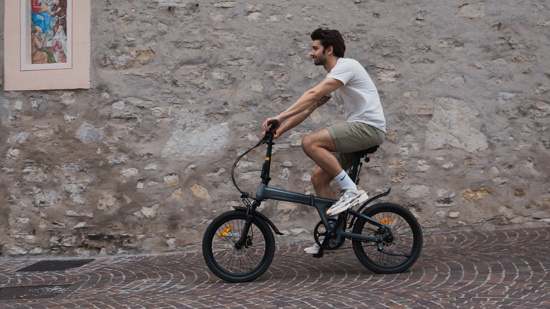 Man cycling electric bike through the streets.